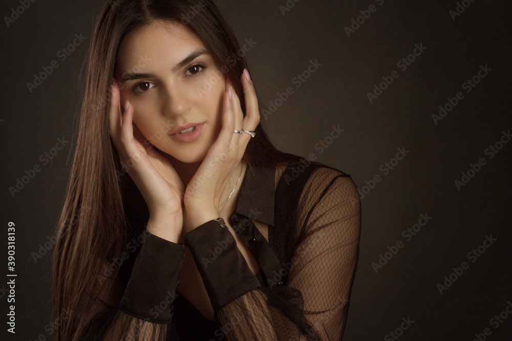 Head shot portrait of a young, beautiful fashion woman touching the perfect smooth skin of her face. Head shot portrait of a young, beautiful fashion woman touching the perfect smooth skin of her face.