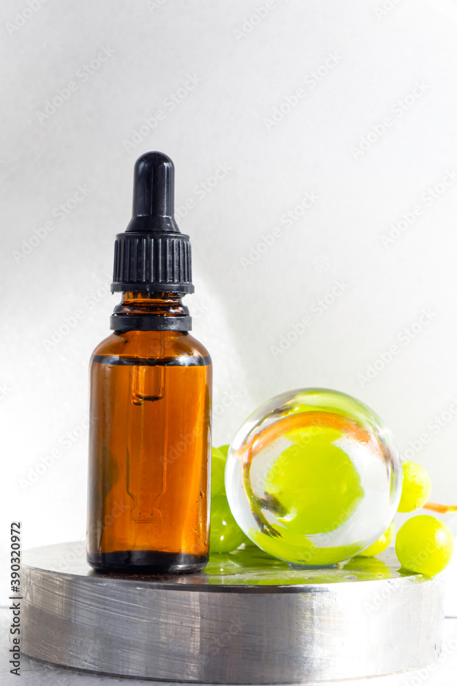 Grape seed oil in glass bottle with fresh grape Grape seed oil in glass bottle with fresh grape