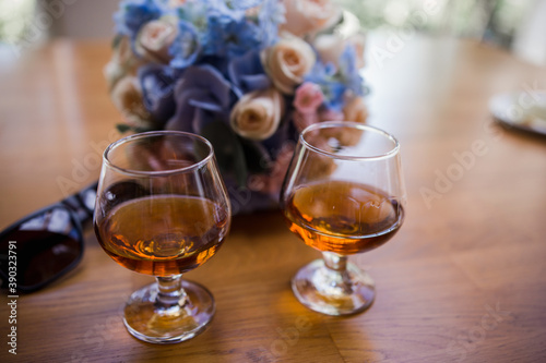glasses with cognac on a wooden table