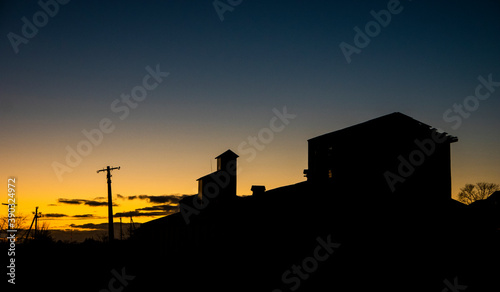 Agricultural buildings on the background of sunset