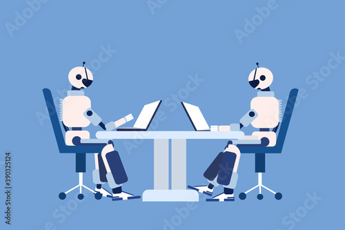 Two robots sitting on chairs and working on their laptops 