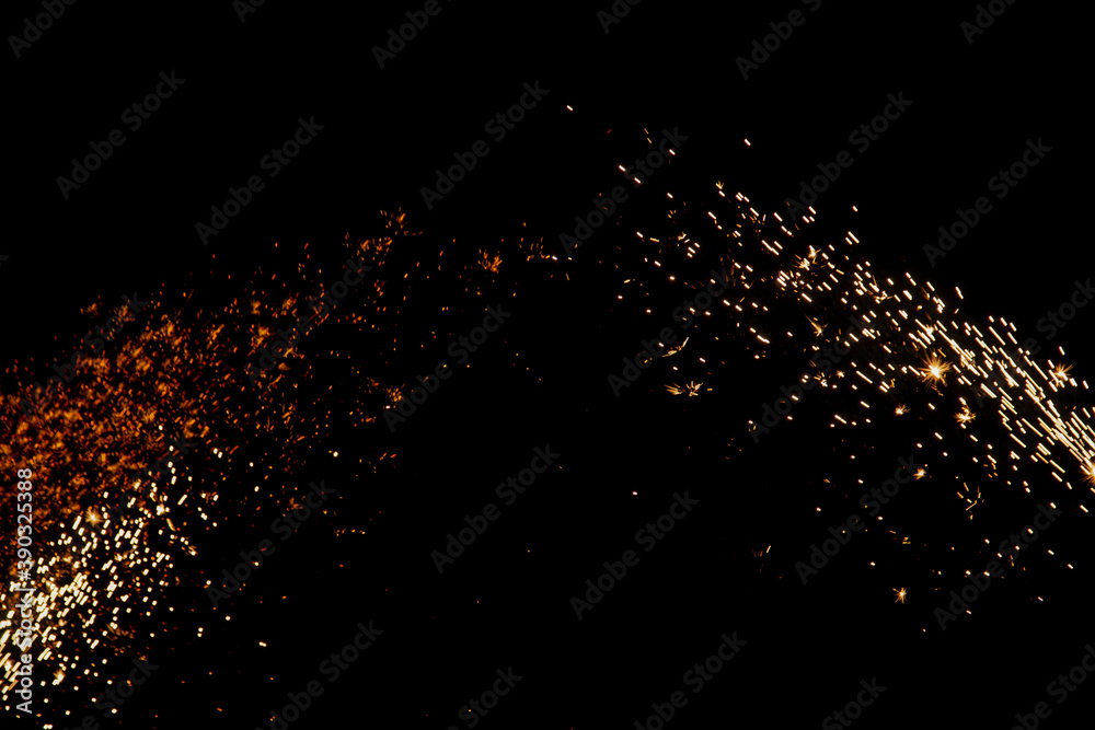 blurry sparks from fireworks on black background