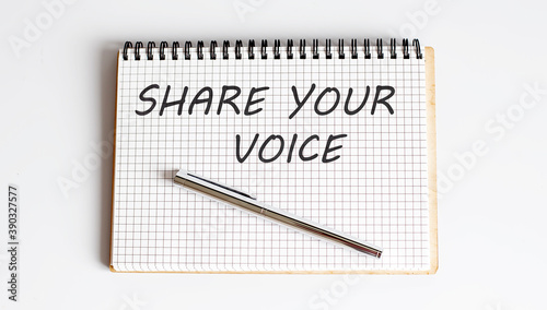 Notebook with pen and Notes about SHARE YOUR VOICE