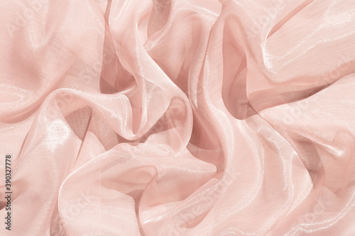 Pink abstract satin background with folds.