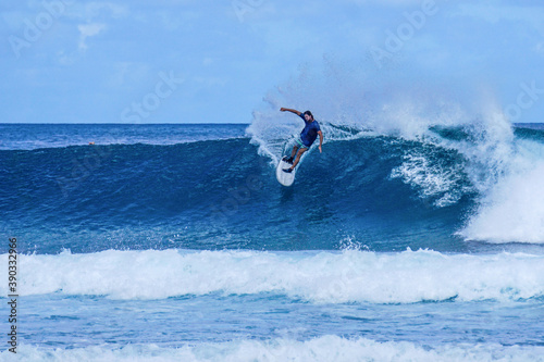 Surfer on perfect blue aquamarine wave, empty line up, perfect for surfing, clean water, Indian Ocean