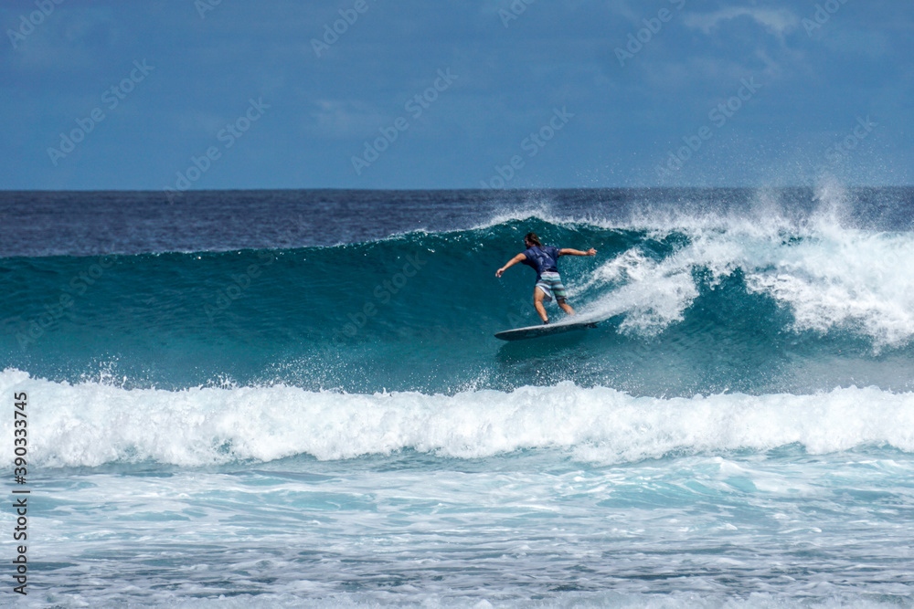 Surfer on perfect blue aquamarine wave, empty line up, perfect for surfing, clean water, Indian Ocean .