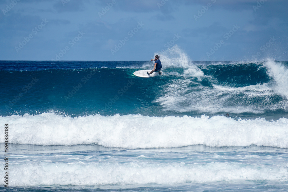 Surfer on perfect blue aquamarine wave, empty line up, perfect for surfing, clean water, Indian Ocean Surfer on perfect blue aquamarine wave, empty line up, perfect for surfing, clean water, Indian Ocean