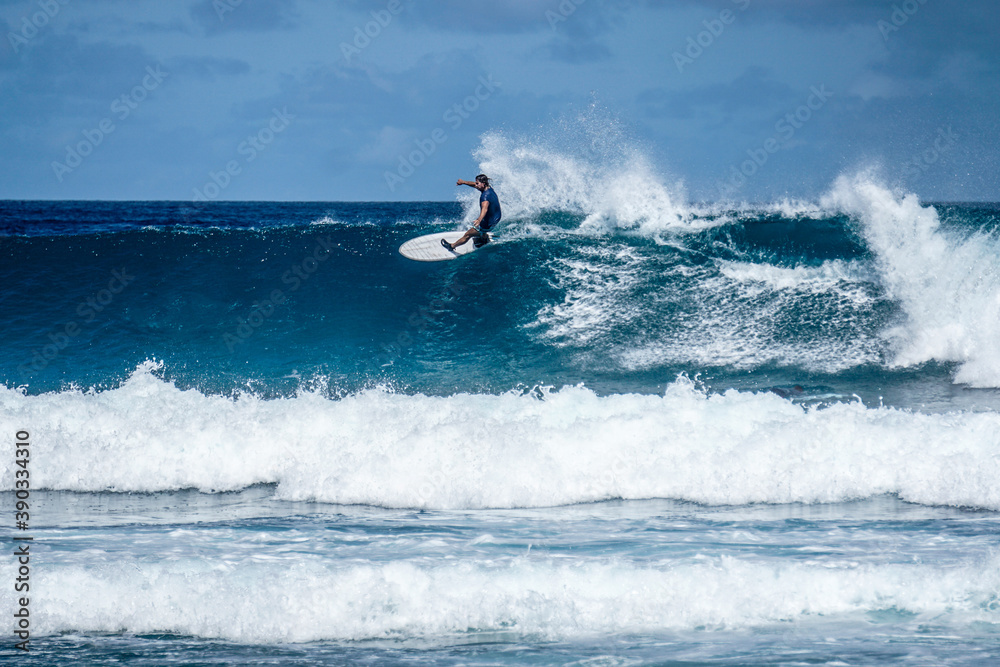 Surfer on perfect blue aquamarine wave, empty line up, perfect for surfing, clean water, Indian Ocean Surfer on perfect blue aquamarine wave, empty line up, perfect for surfing, clean water, Indian Ocean
