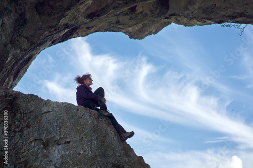 Woman hiker standing on the cliff in a doline