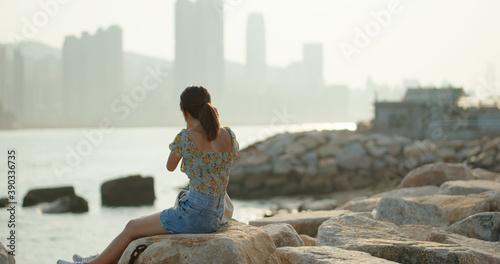 Photography Woman plays with camera and sits beside the sea