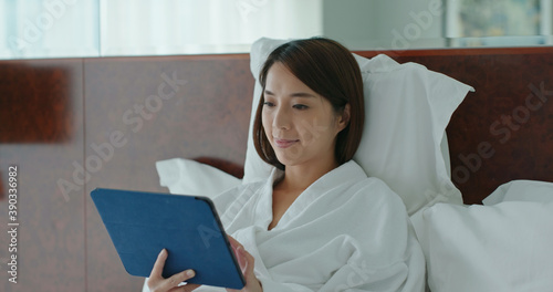 Woman use of tablet computer on bed