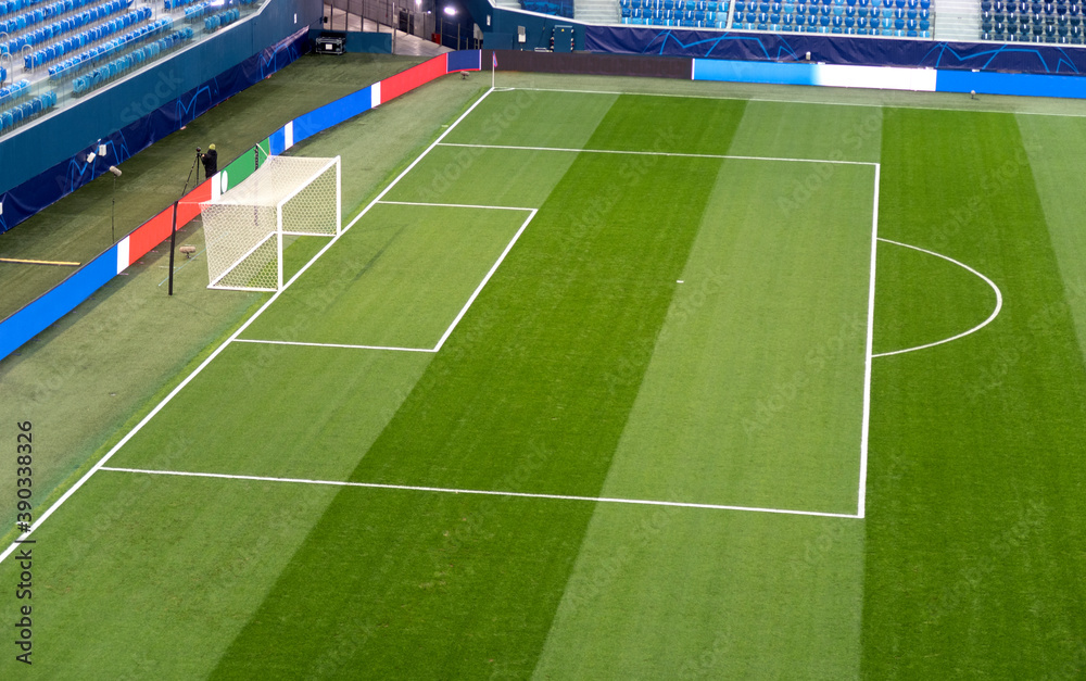 Fototapeta premium Soccer. Empty football field before the match. Green artificial turf surface and white field lines in a football or soccer playing field. 