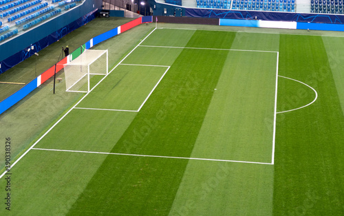Soccer. Empty football field before the match. Green artificial turf surface and white field lines in a football or soccer playing field.  © maxcam