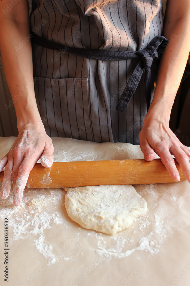 Household. Women's hands roll out the dough. Family celebration. Household. Women's hands roll out the dough. Family celebration.