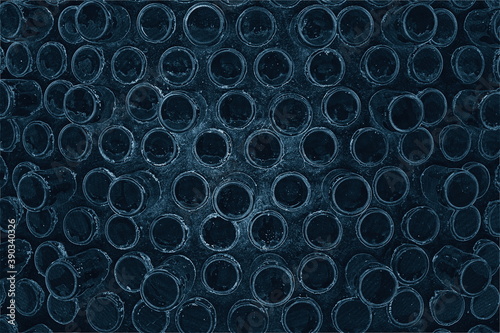 Creative wall made of many bottles with concrete in navy blue background