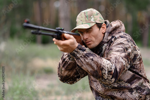 Young Man is Aiming with Shotgun Rabbit Hunt.