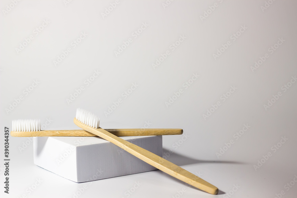 bamboo wooden toothbrushes on white background with stand and craft glass. care for ecology and the environment. hygiene. bamboo wooden toothbrushes on white background with stand and craft glass. care for ecology and the environment. hygiene.