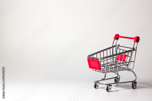 empty supermarket trolley on a white background. promotion, sale, black friday. © Nastia