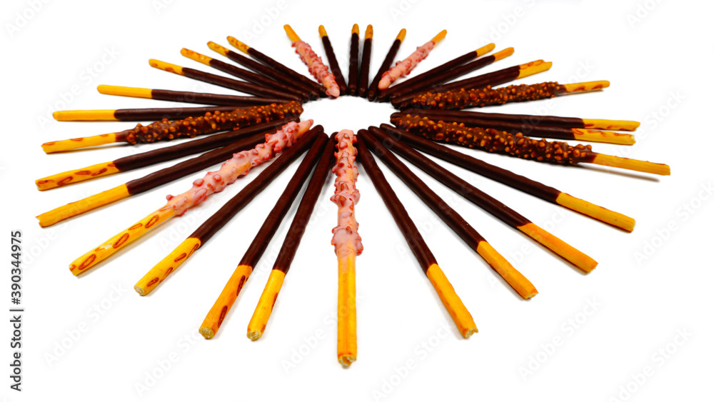 Close up of chocolate sticks of various flavors in a round shape. Isolated on white background. Original, Strawberry Flavored, Crunchy. Assorted chocolate dipped biscuits sticks,