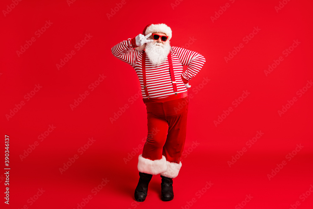 Full length body size view of his he nice handsome cheery comic childish flirty Santa father having fun celebratory festal day showing v-sign isolated bright vivid shine vibrant red color background - obrazy, fototapety, plakaty 