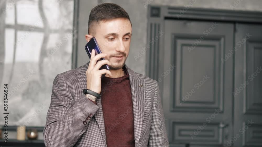 Young successful bearded businessman standing using mobile phone, calling talking on phone with partners, modern technology communication success internet Young successful bearded businessman standing using mobile phone, calling talking on phone with partners, modern technology communication success internet