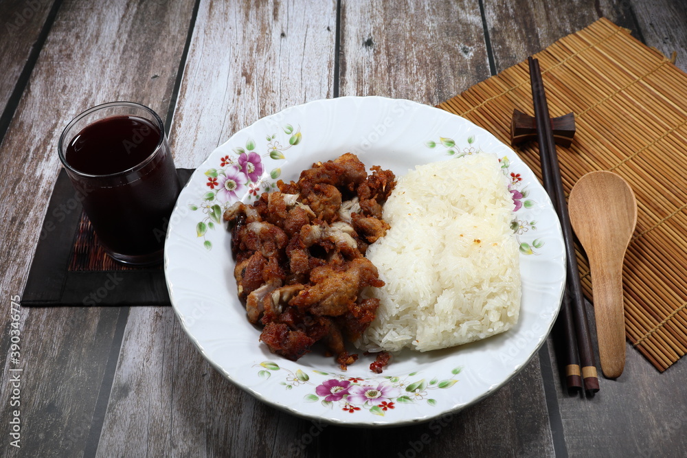 Sticky rice serving with mixed deep fried pork and chicken on the plate. Famous traditional breakfast menu in Asia. 