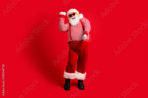Full length body size view of his he handsome bearded fat overweight cheery glad childish Santa listening melody dancing amusement isolated bright vivid shine vibrant red color background