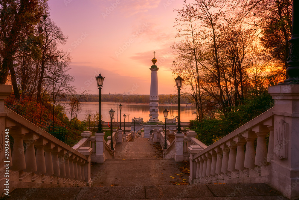 Stairs to the park Volodymyrska Hirka or Saint Volodymyr Hill at sunrise, Kyiv (Kiev), Ukraine. Scenic view to the Dnieper river and Monument to the Magdeburg Rights, scenic landscape