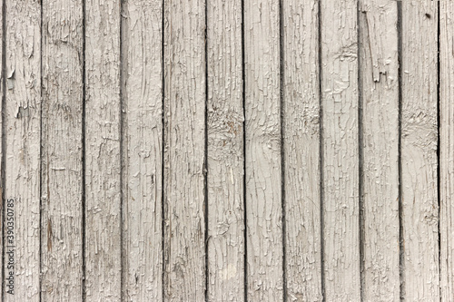 The surface of old wooden boards with peeling and weathered paint.