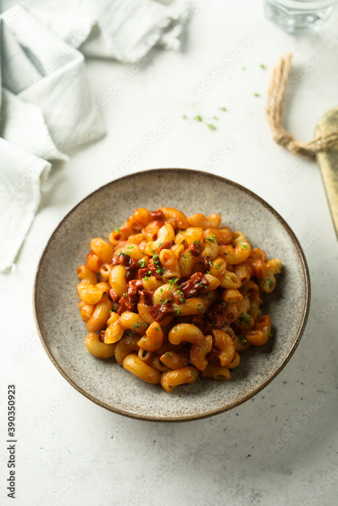 Fototapeta premium Pasta with tomato sauce and salami