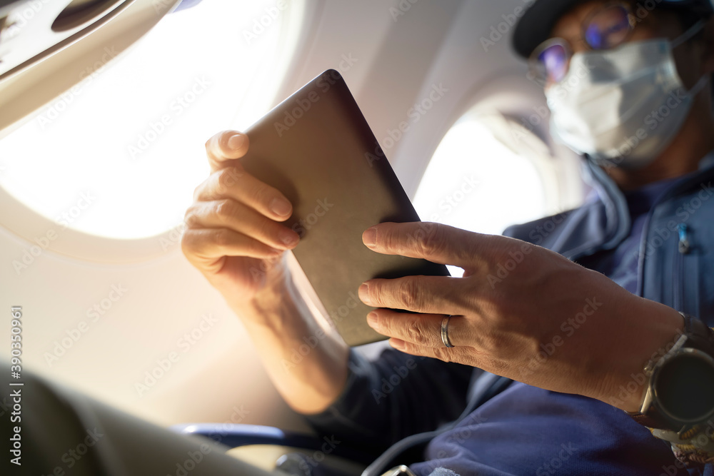 asian man male air traveler reading ebook on flight