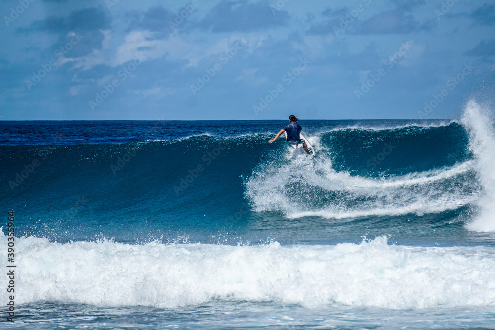 Surfer on perfect blue aquamarine wave, empty line up, perfect for surfing, clean water, Indian Ocean Surfer on perfect blue aquamarine wave, empty line up, perfect for surfing, clean water, Indian Ocean