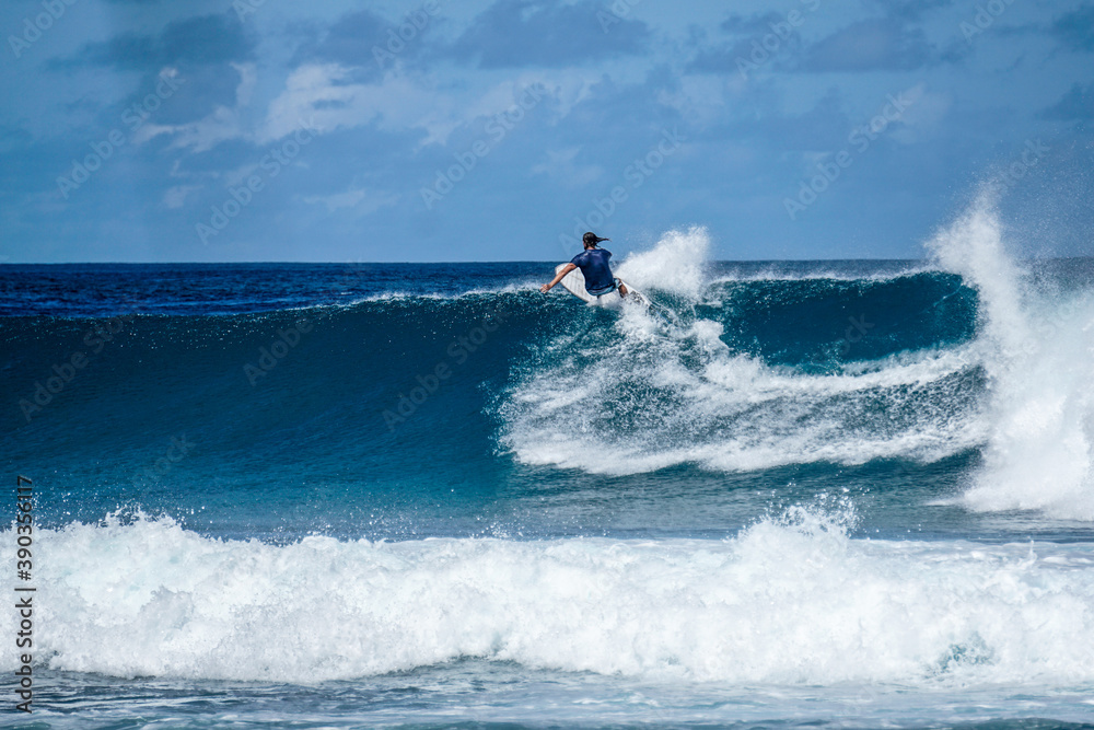Surfer on perfect blue aquamarine wave, empty line up, perfect for surfing, clean water, Indian Ocean Surfer on perfect blue aquamarine wave, empty line up, perfect for surfing, clean water, Indian Ocean