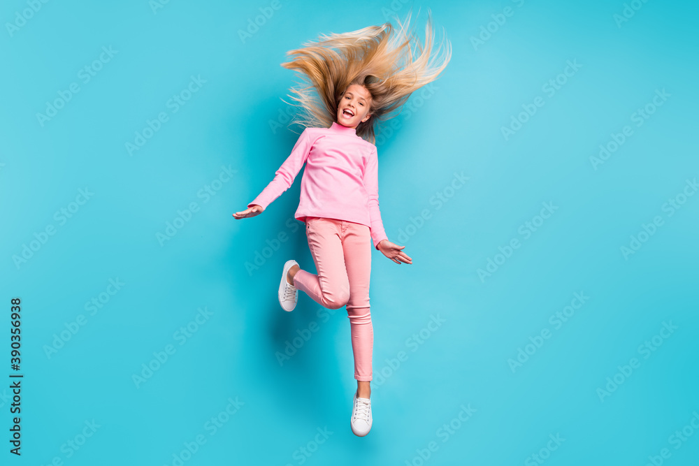 Full size photo of amazed positive teenage girl jump hair up wear pink pants poloneck white footwear isolated on teal background Full size photo of amazed positive teenage girl jump hair up wear pink pants poloneck white footwear isolated on teal background