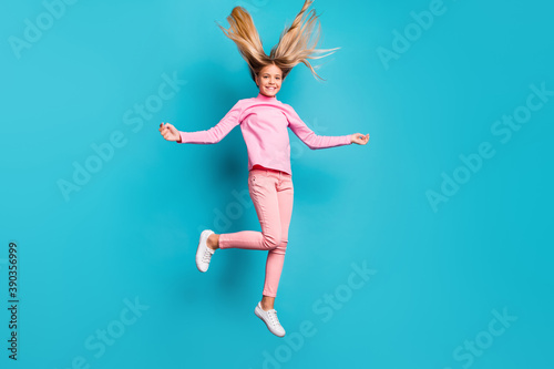 Fototapeta Naklejka Na Ścianę i Meble -  Full size photo of funny positive teenager jump hair up wear pink pants poloneck white footwear isolated on teal background