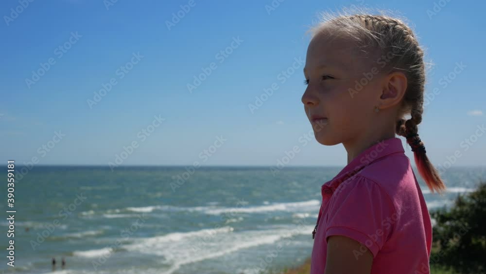portrait of a girl against the background of the sea. Child at sea portrait of a girl against the background of the sea. Child at sea