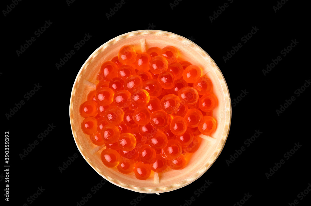Red caviar tartlets isolated on a black background. Red caviar tartlets isolated on a black background.