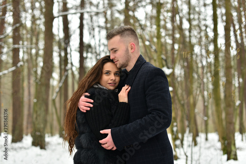 The concept of romance and love. Winter love story. smile, hugs and kiss of a couple in love.