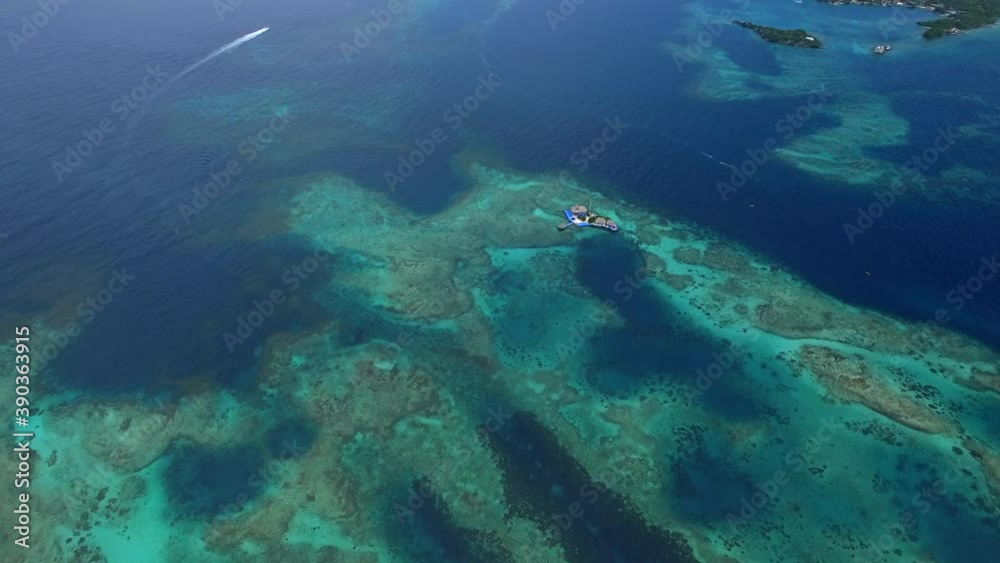 Aerial view of coral reefs at Rosario Islands (Spanish: Islas del Rosario ) off the coast of Cartagena de Indias, Colombia. Aerial view of coral reefs at Rosario Islands (Spanish: Islas del Rosario ) off the coast of Cartagena de Indias, Colombia.