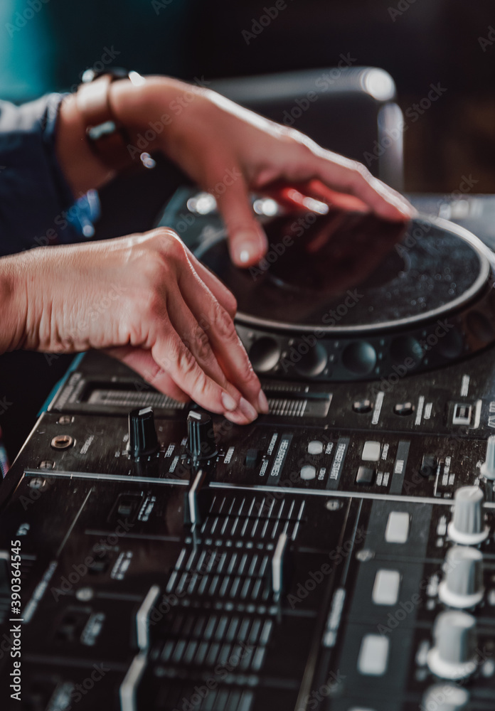 DJ Hands creating and regulating music on dj console mixer in concert nightclub stage DJ Hands creating and regulating music on dj console mixer in concert nightclub stage