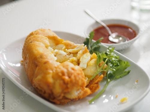 Thai style crab omelet, egg yellow food on white plate