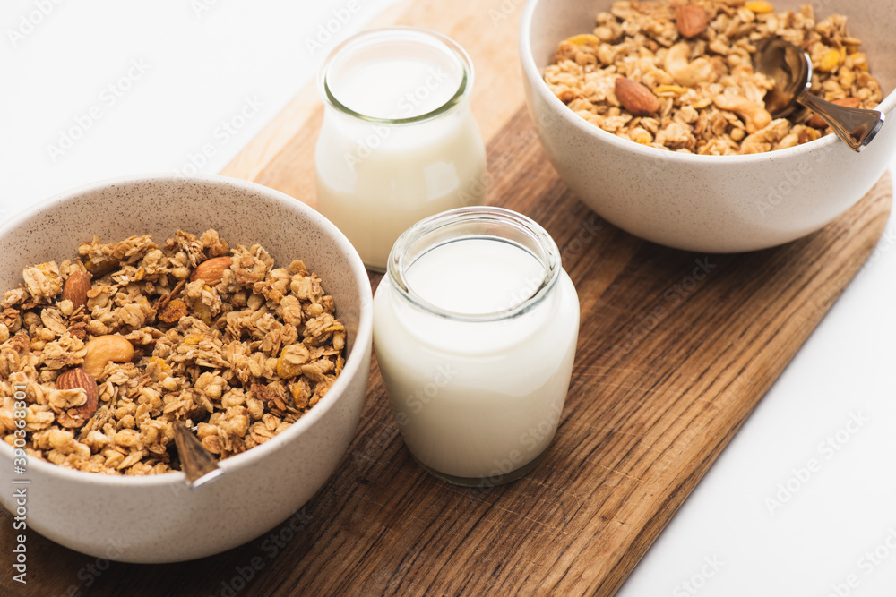 delicious granola with nuts and yogurt isolated on white delicious granola with nuts and yogurt isolated on white