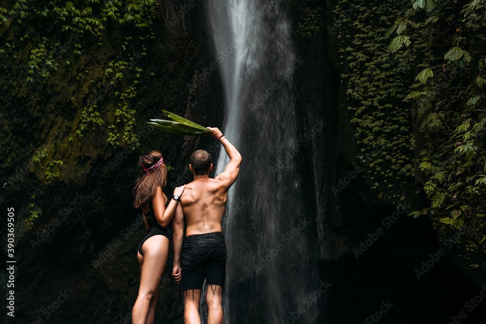 Beautiful Couple At A Waterfall In Indonesia Rear View Man And Woman At The Waterfall A 3336