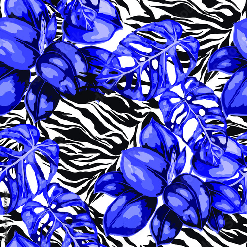 Tropical seamless pattern on animalistic texture. Jungle exotic summer print. Summer tropical leaf. Tropical flower fashion pattern. Floral tropic illustration. Vector seamless pattern.	