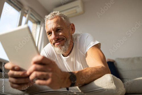 Man looking with interest at a tablet screen