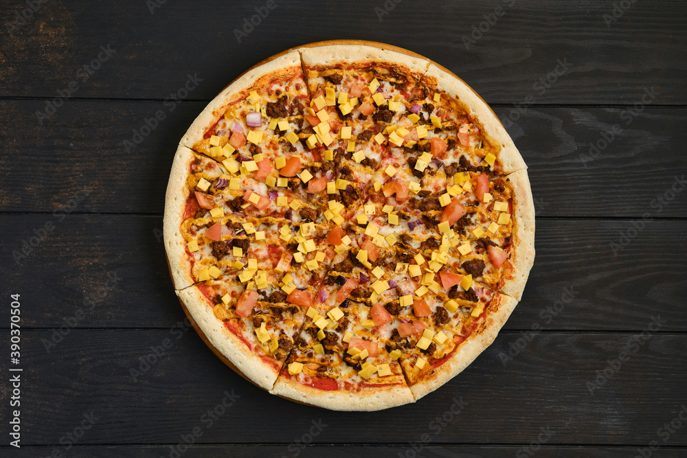 Top view of pizza with minced meat, tomato, onion and cheddar