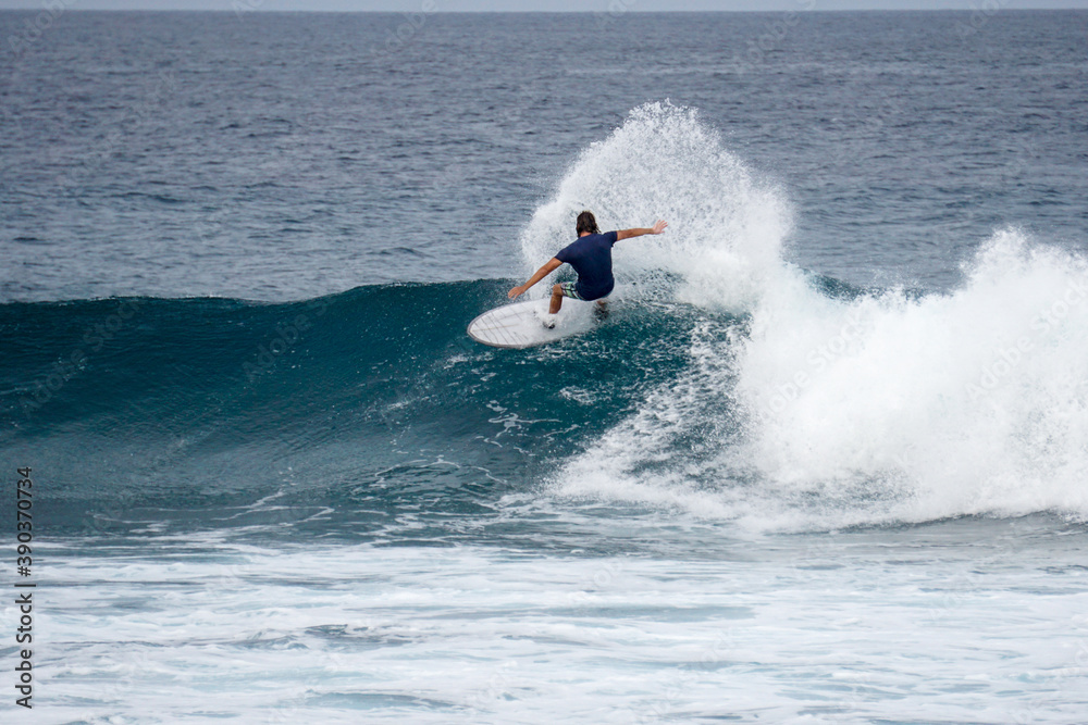 Surfer on perfect blue aquamarine wave, empty line up, perfect for surfing, clean water, Indian Ocean Surfer on perfect blue aquamarine wave, empty line up, perfect for surfing, clean water, Indian Ocean
