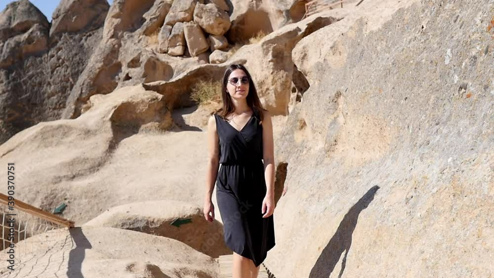 The young woman looks around admiringly. Woman in a cave on an excursion in Cappadocia. The young woman looks around admiringly. Woman in a cave on an excursion in Cappadocia.