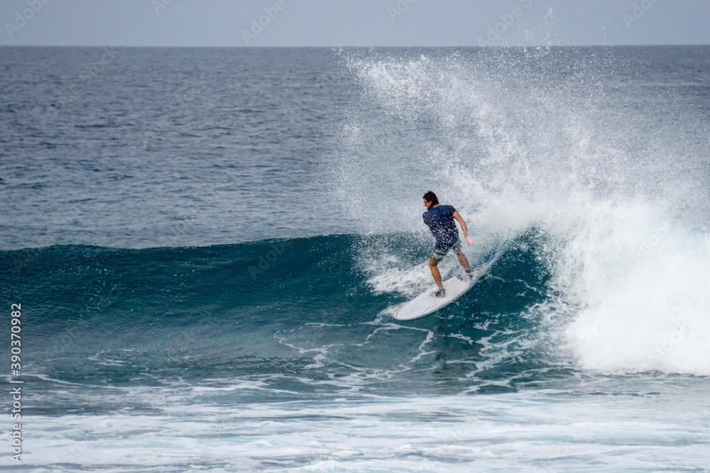 Surfer on perfect blue aquamarine wave, empty line up, perfect for surfing, clean water, Indian Ocean Surfer on perfect blue aquamarine wave, empty line up, perfect for surfing, clean water, Indian Ocean