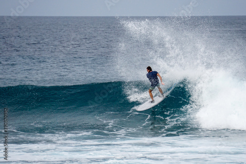 Surfer on perfect blue aquamarine wave, empty line up, perfect for surfing, clean water, Indian Ocean